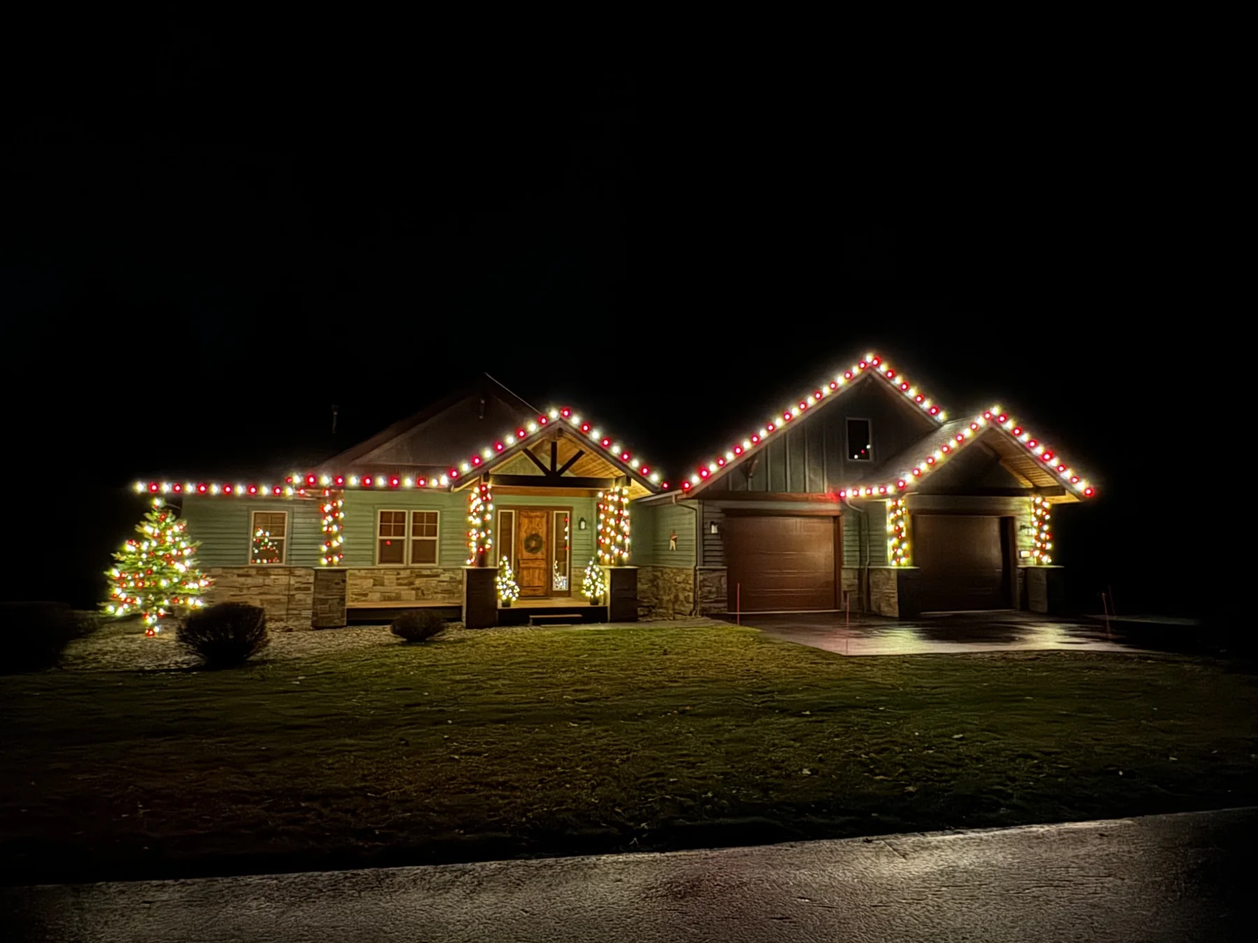 Red and white Christmas lights on a professionally installed home display